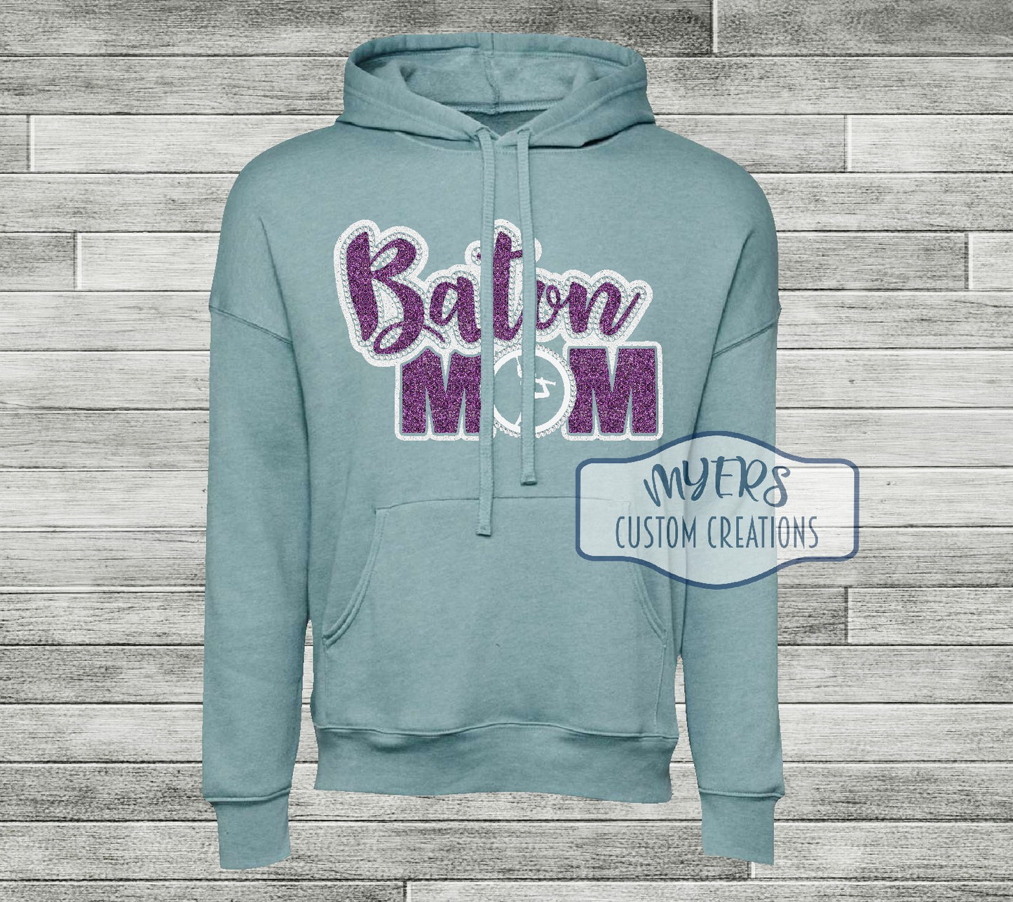 Baton Mom heather blue lagoon Bella+Canvas hoodie with white glitter and lavender glitter HTV and crystal rhinestones