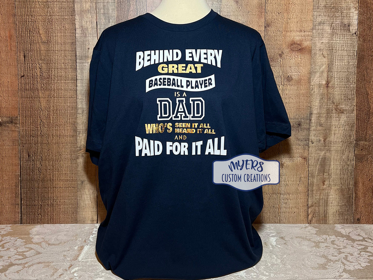 Behind Every Great Baseball Player Dad navy Bella+Canvas XL t-shirt with white & metallic gold HTV