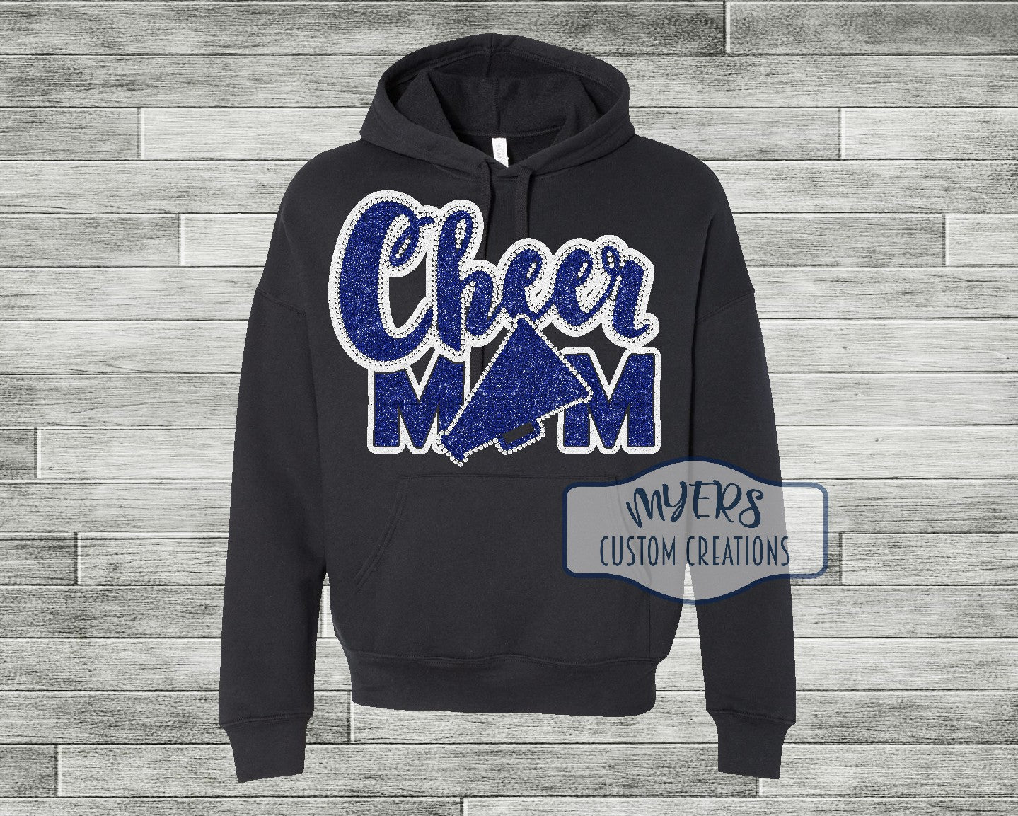Cheer Mom black Bella Canvas hoodie with white glitter and royal blue glitter HTV and crystal rhinestones