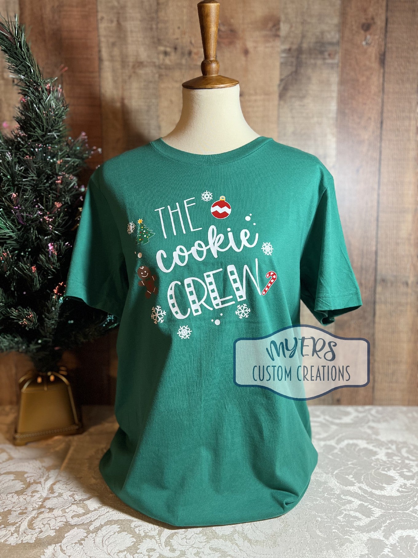 The Cookie Crew kelly green Bella+Canvas t-shirt with white, red, green, chocolate, & yellow HTV
