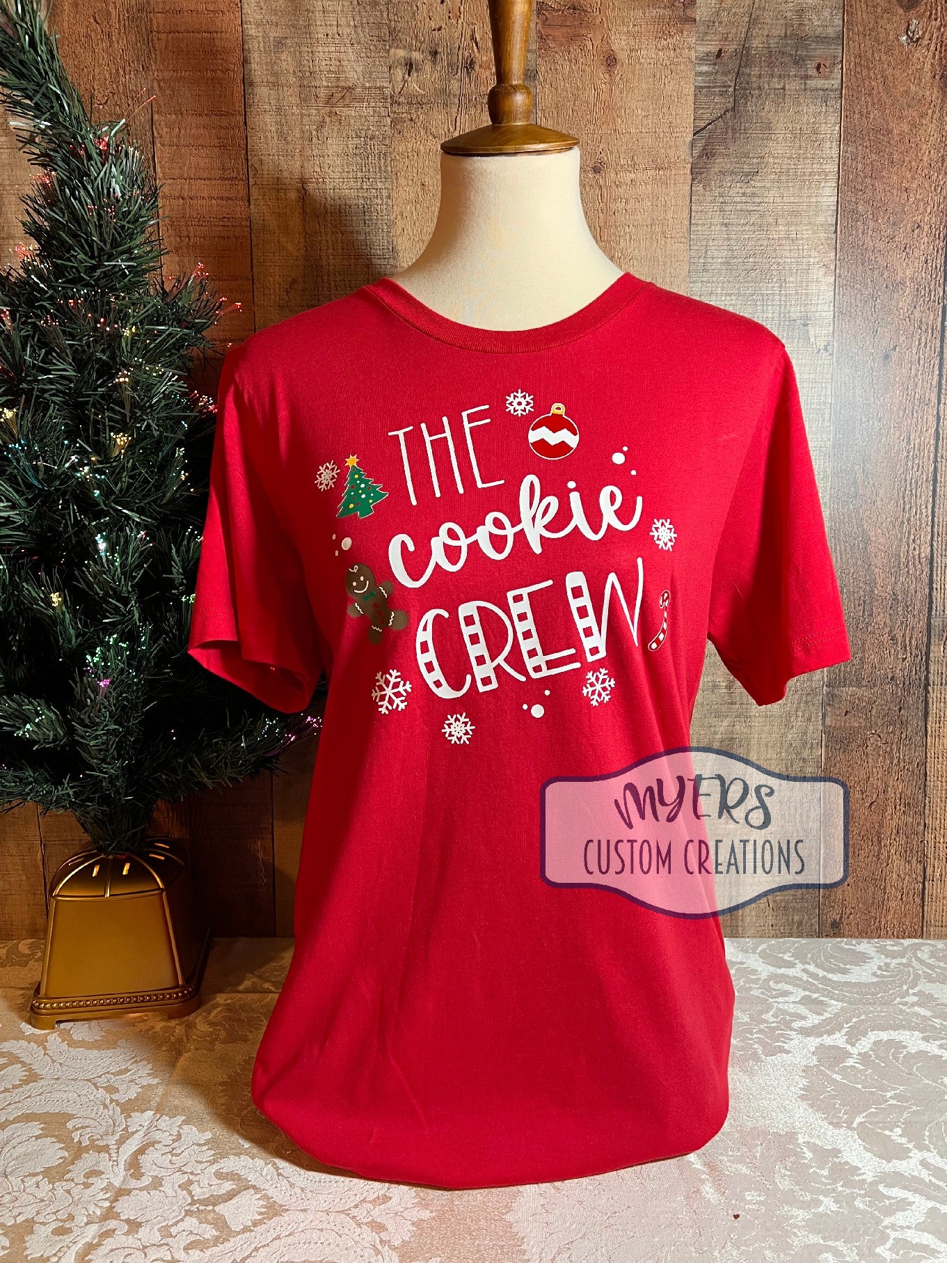 The Cookie Crew red Bella+Canvas t-shirt with white, red, green, chocolate, & yellow HTV