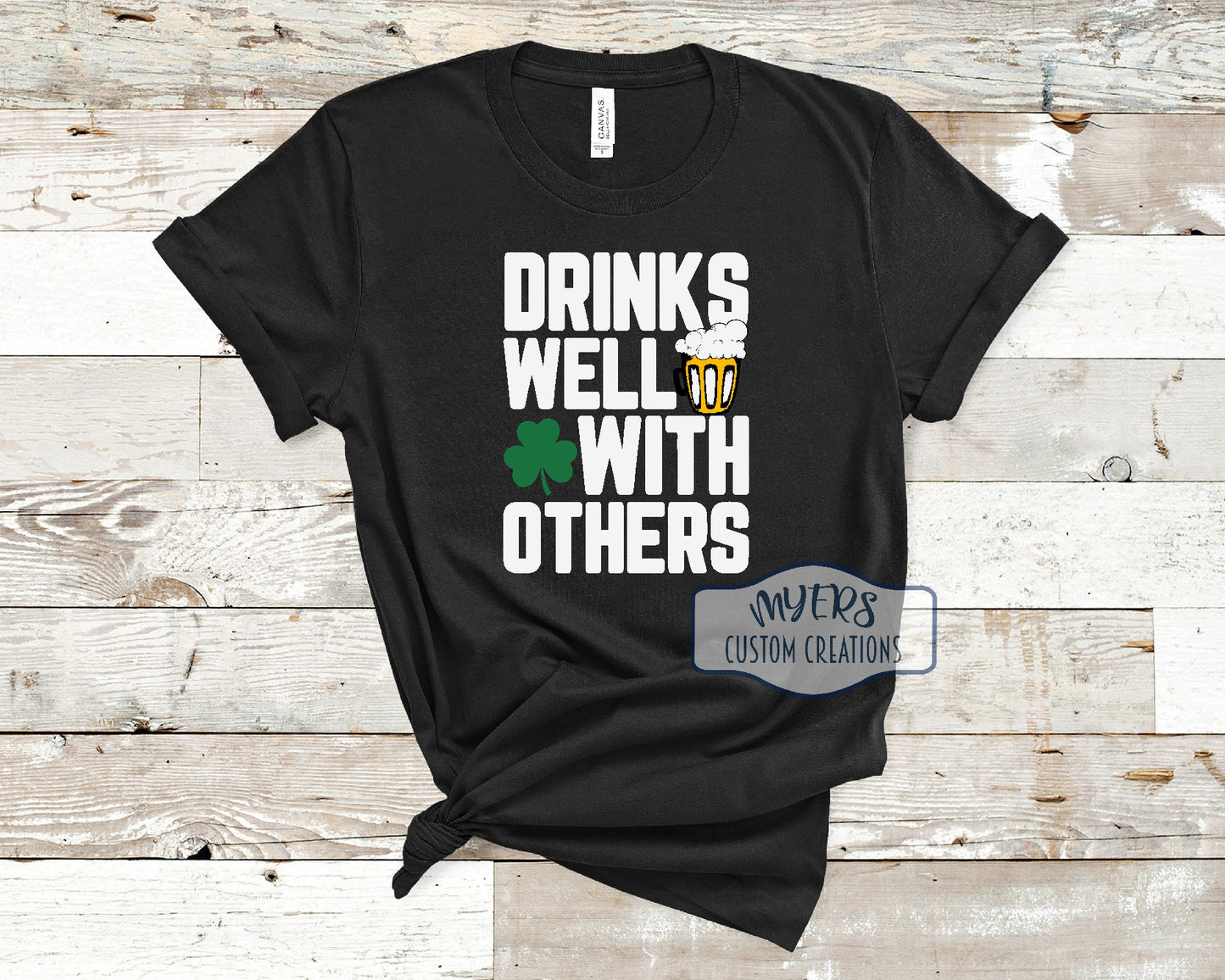Drinks Well With Others black Bella Canvas t-shirt with white, black, green, and sun HTV