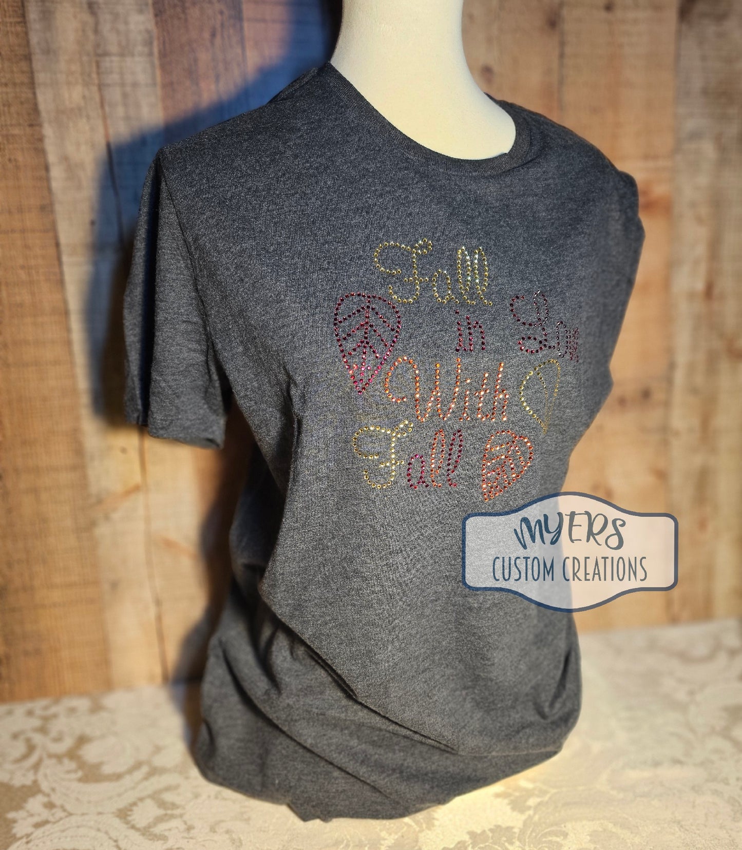 Fall in Love With Fall Rhinestone Heather Dark Grey Bella+Canvas t-shirt with Light Topaz, Orange, & Red Siam rhinestones.