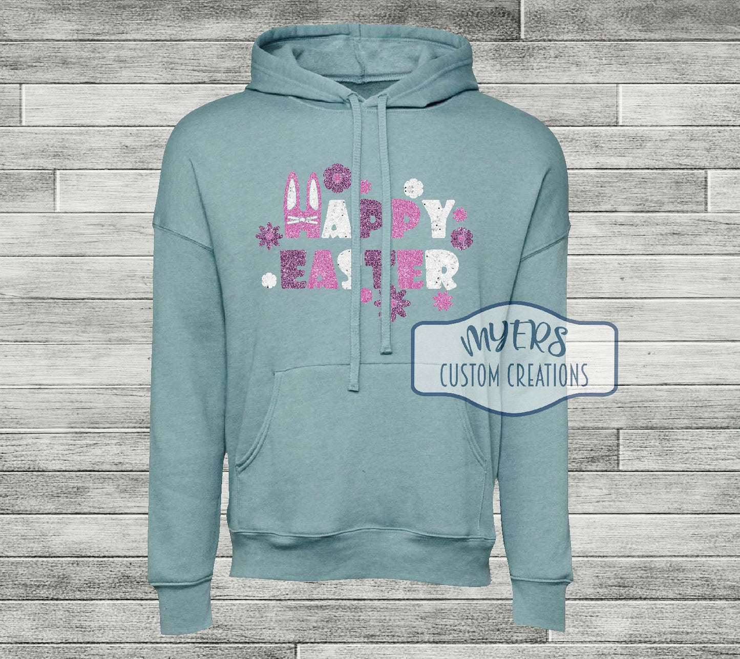 Happy Easter heather blue lagoon Bella Canvas hoodie with flamingo pink glitter, white glitter, and lavender glitter HTV