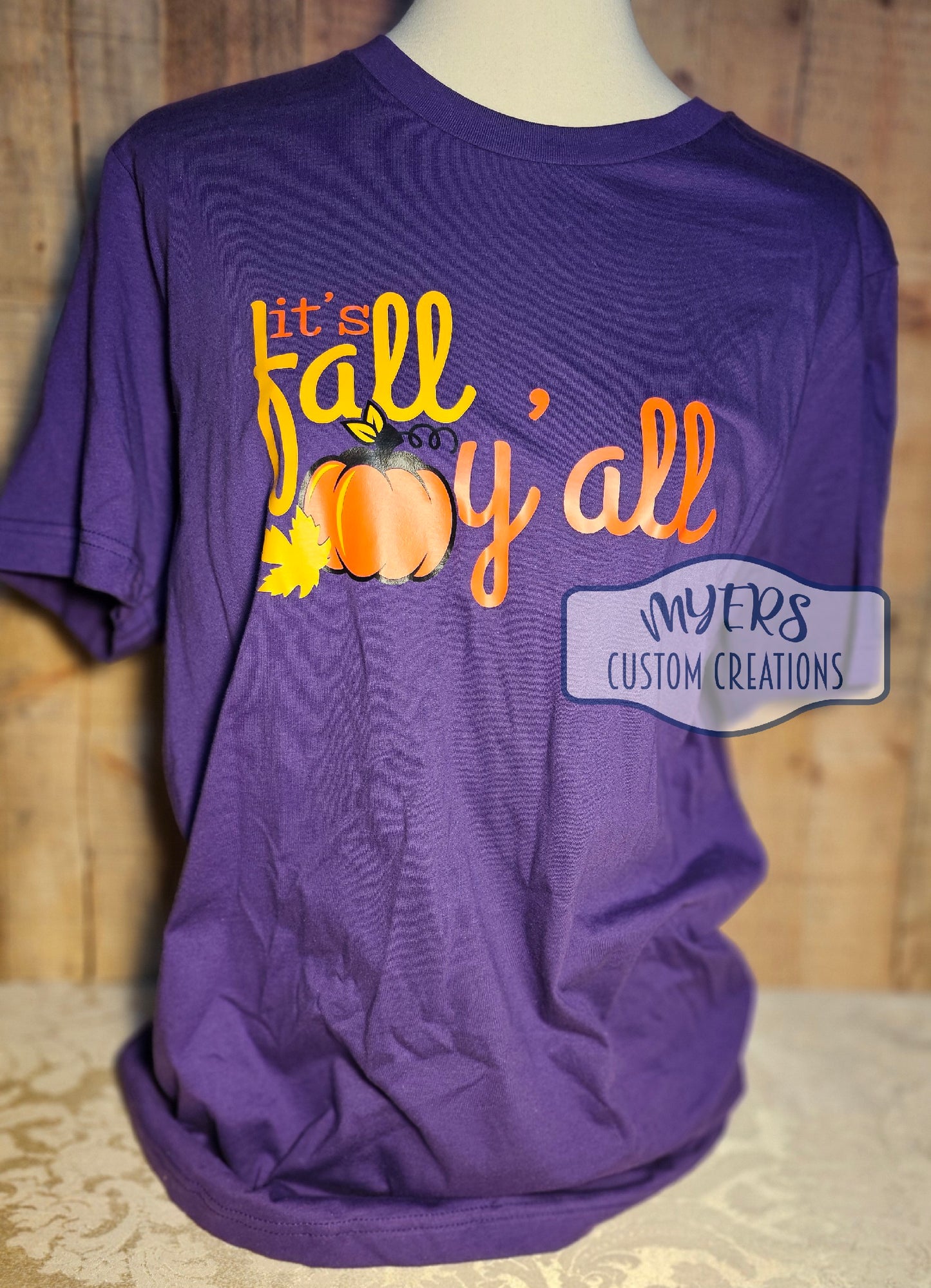 It's Fall Y'all purple Bella+Canvas t-shirt with orange, sun, and black HTV