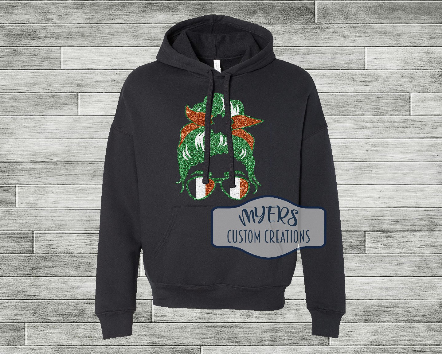 Messy Bun St. Patricks Day black Bella Canvas hoodie with green glitter, copper glitter, and white glitter HTV