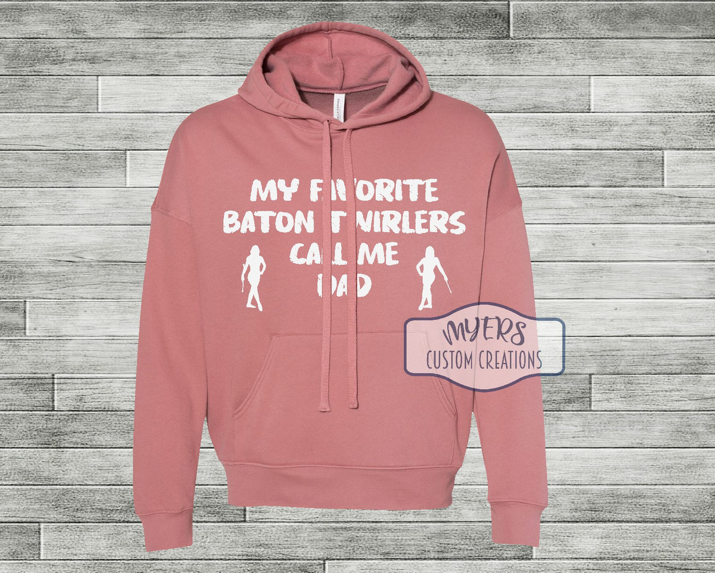 My Favorite Baton Twirlers Call Me Dad mauve Bella Canvas hoodie with 2 female twirler silhouettes and White HTV