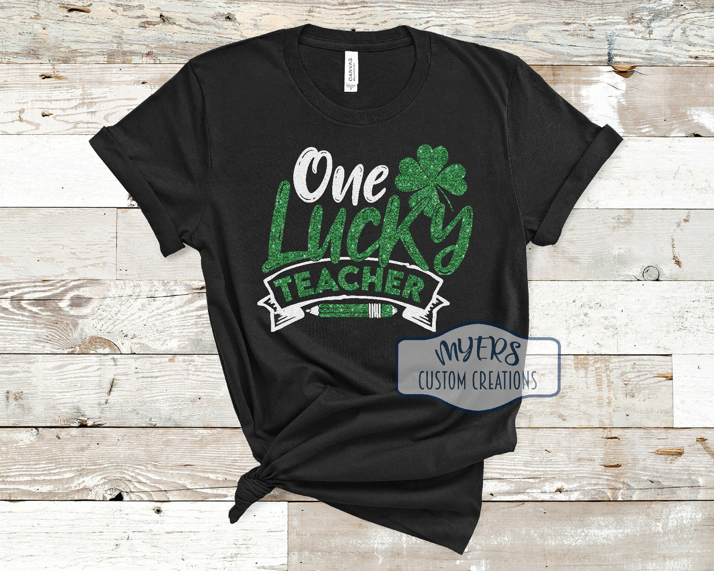 One Lucky Teacher black Bella Canvas t-shirt with white glitter and green glitter HTV