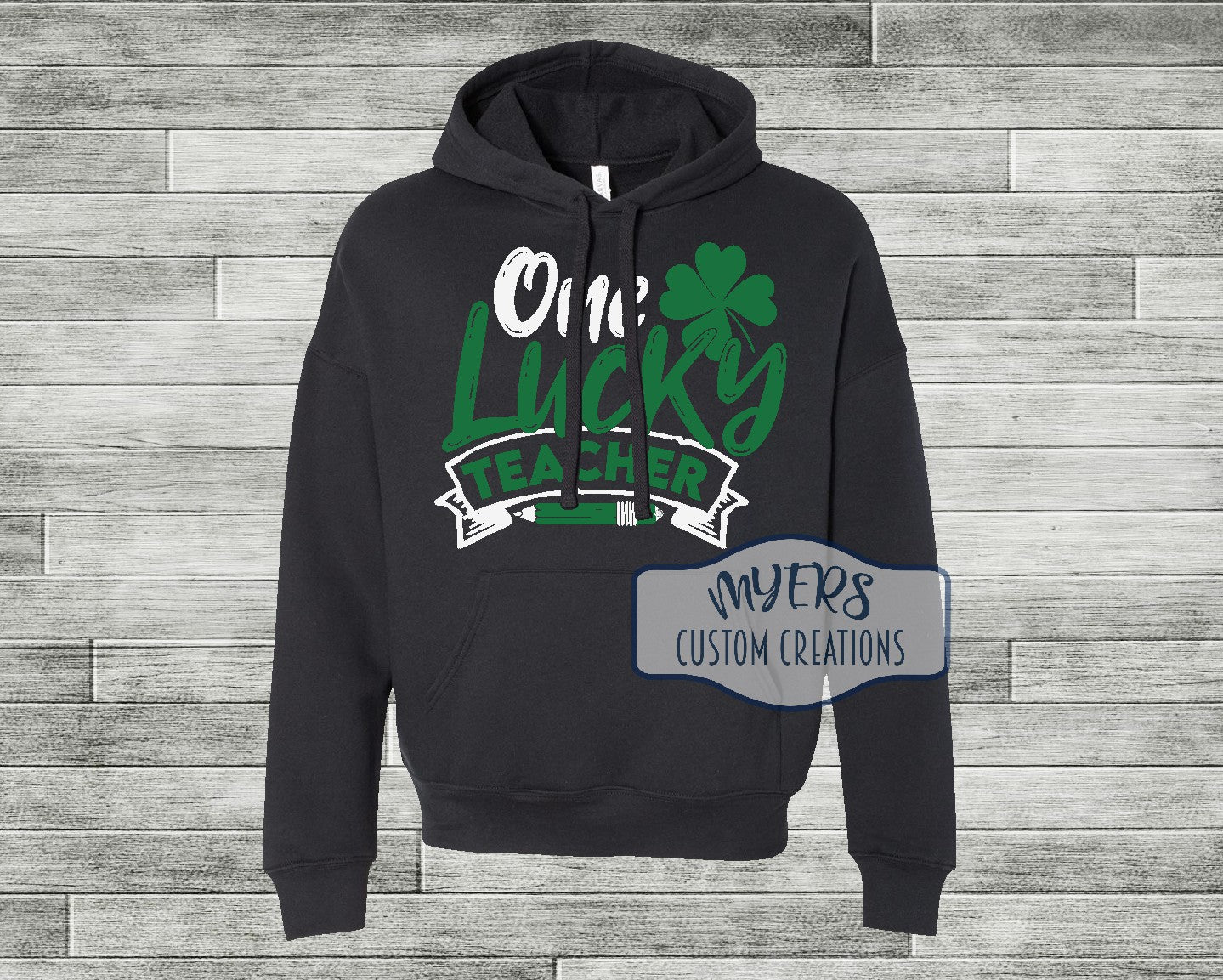 One Lucky Teacher black Bella Canvas hoodie with white and green HTV