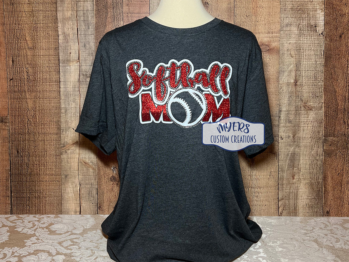 Softball Mom Multi-Dec heather dark grey t-shirt with white and red glitter HTV and crystal rhinestones