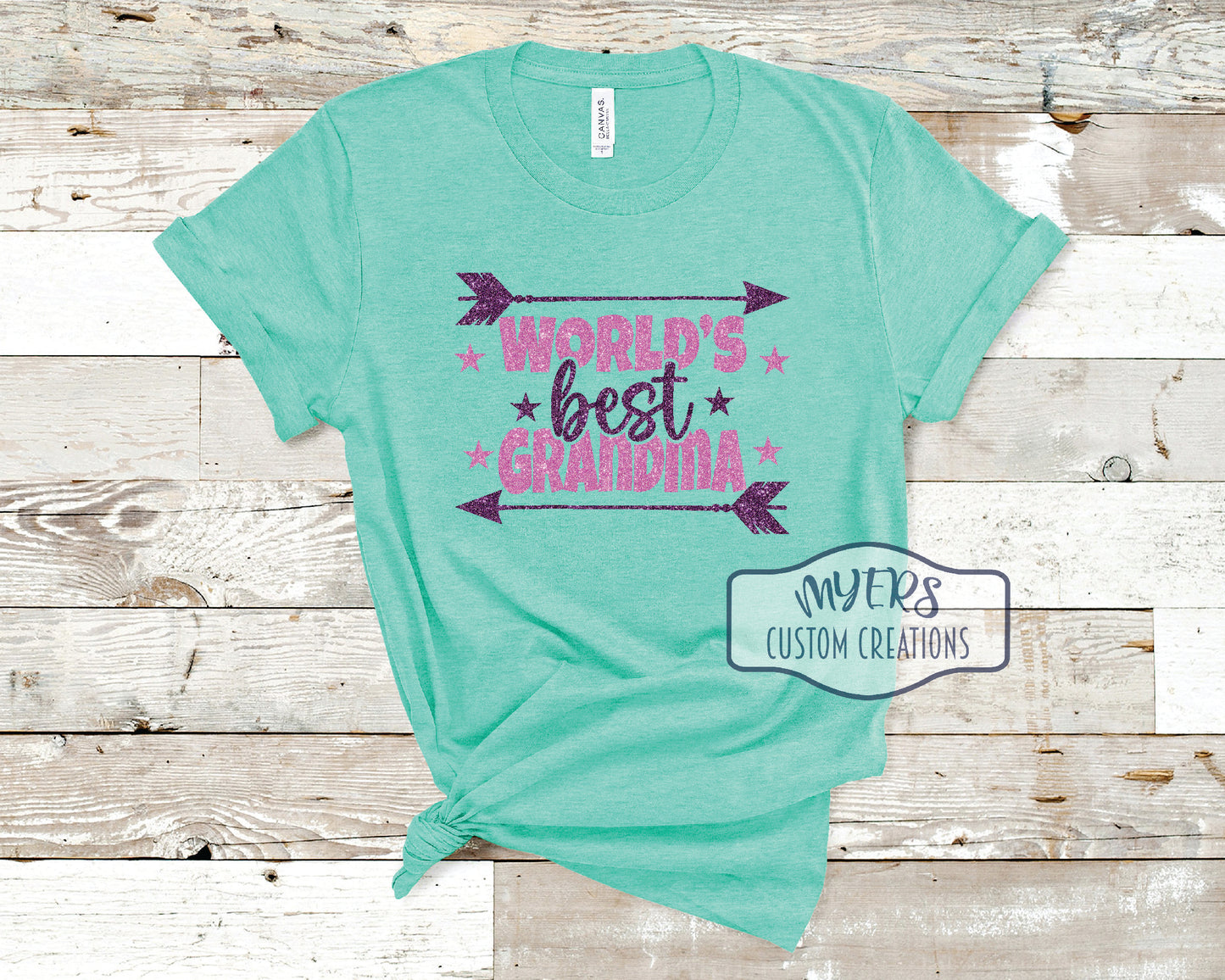 World's Best Grandma heather sea green Bella+Canvas t-shirt with purple glitter and flamingo pink glitter HTV