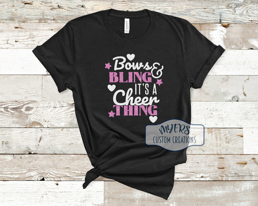 Bows & Bling It's a Cheer Thing black Bella Canvas t-shirt with white glitter and flamingo pink glitter HTV
