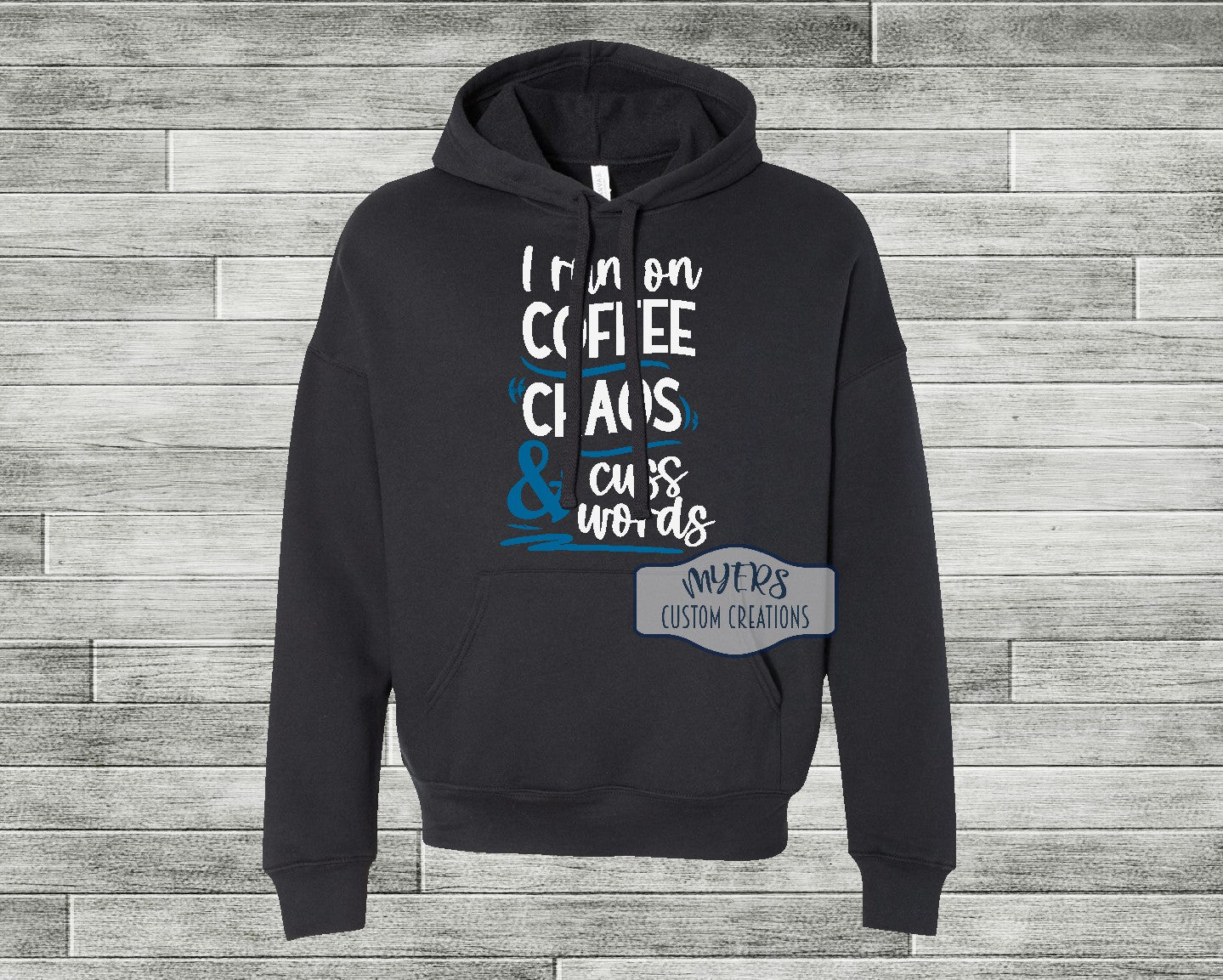 I Run on Coffee Chaos & Cuss Words black Bella+Canvas hoodie with white and sky blue HTV