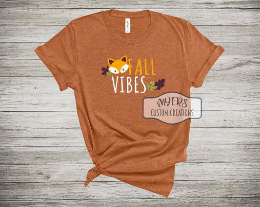 Fall Vibes on Heather Autumn Bella+Canvas t-shirt with sun, white, gold glitter, maroon, and chocolate HTV