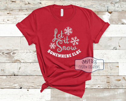 Let it Snow Somewhere Else on a red t-shirt with silver glitter and white glitter